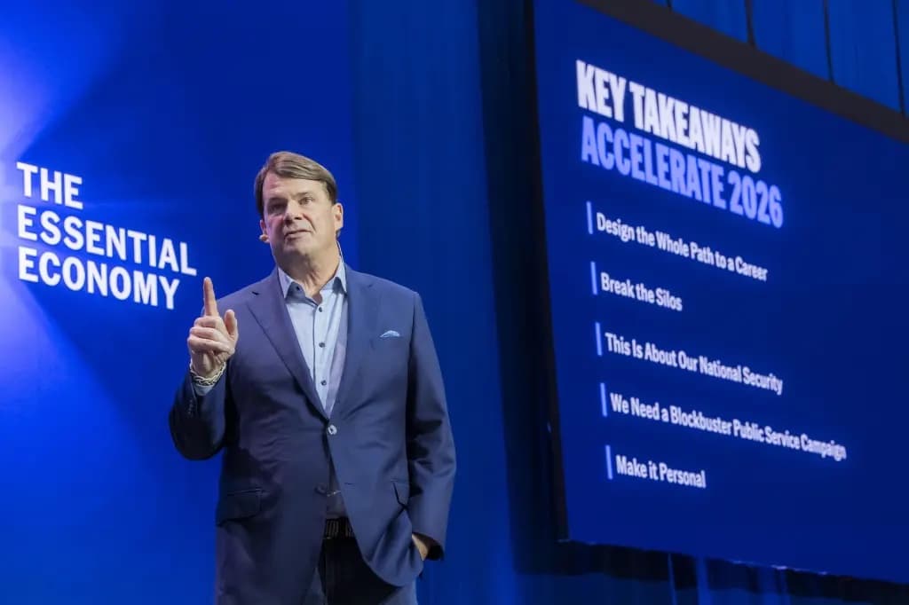 Ford CEO Jim Farley speaking on stage at an event about the essential economy