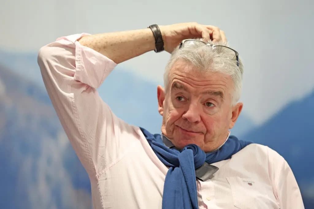 Ryanair CEO Michael O'Leary adjusting his glasses while speaking